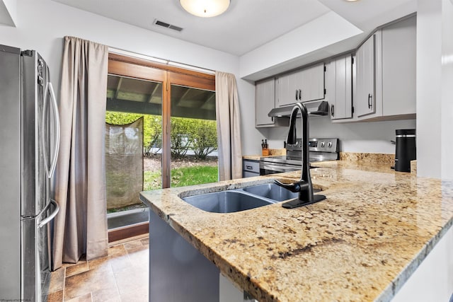 1224 Van Voorhis Rd, Morgantown, WV 26505 - kitchen featuring stainless steel appliances, a peninsula, visible vents, light stone countertops, and under cabinet range hood