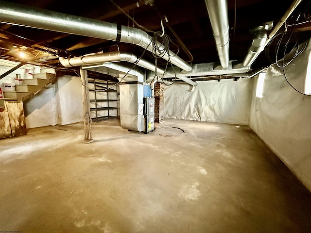 unfinished basement with stairs and heating unit