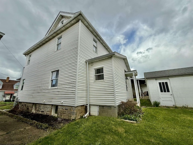 view of property exterior with a yard