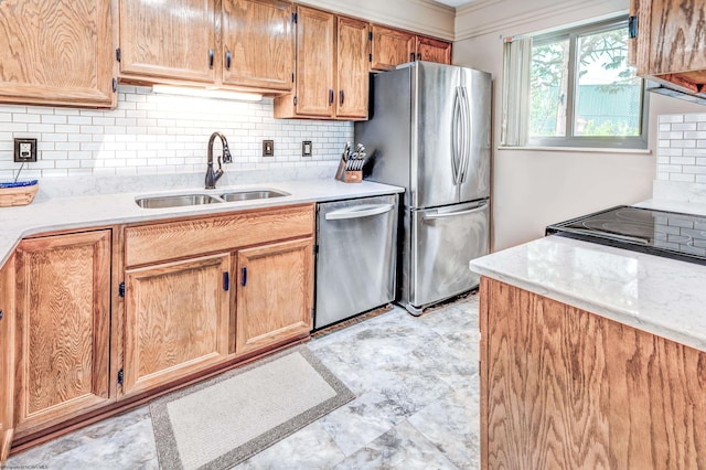 kitchen with decorative backsplash, a sink, and appliances with stainless steel finishes