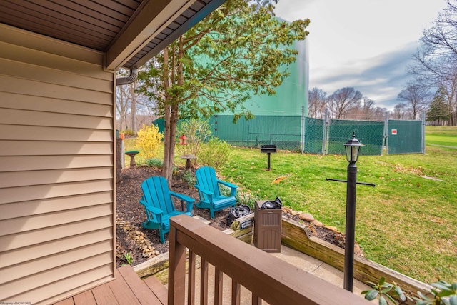 wooden terrace with fence and a lawn