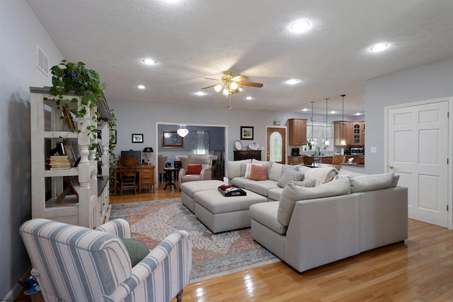 living room with recessed lighting, light wood-style floors, visible vents, and a ceiling fan