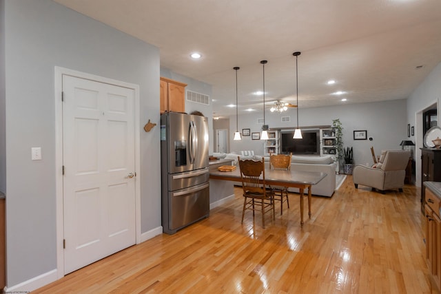 kitchen with open floor plan, visible vents, recessed lighting, light wood-style floors, and stainless steel refrigerator with ice dispenser