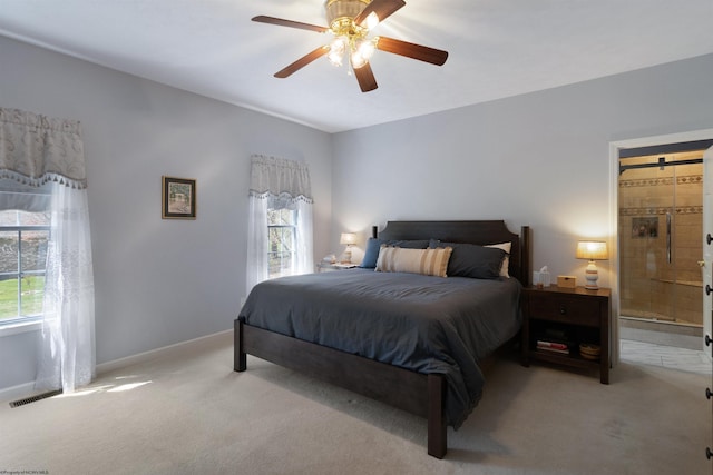 bedroom featuring carpet flooring, baseboards, a ceiling fan, and ensuite bathroom