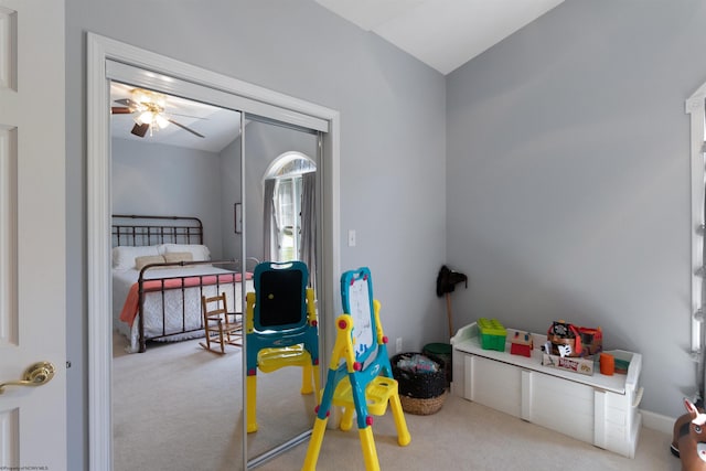 interior space featuring carpet, lofted ceiling, and a ceiling fan