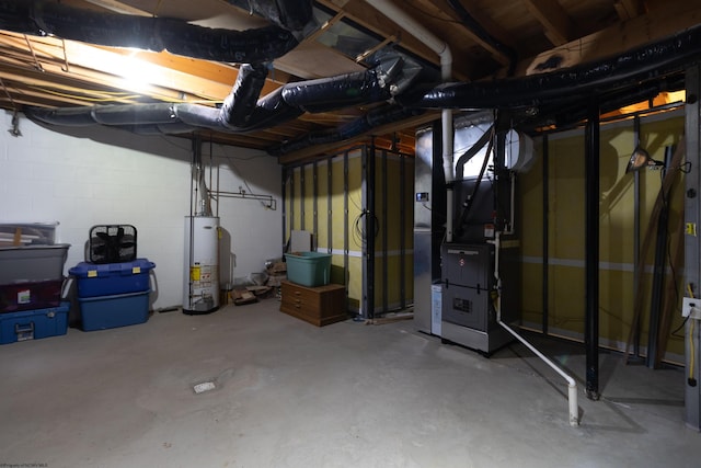 unfinished below grade area featuring concrete block wall, heating unit, and water heater