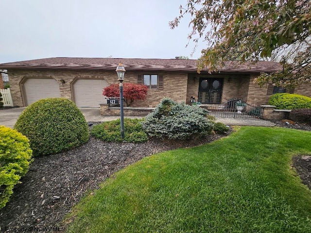 single story home with a front lawn, driveway, french doors, brick siding, and a garage