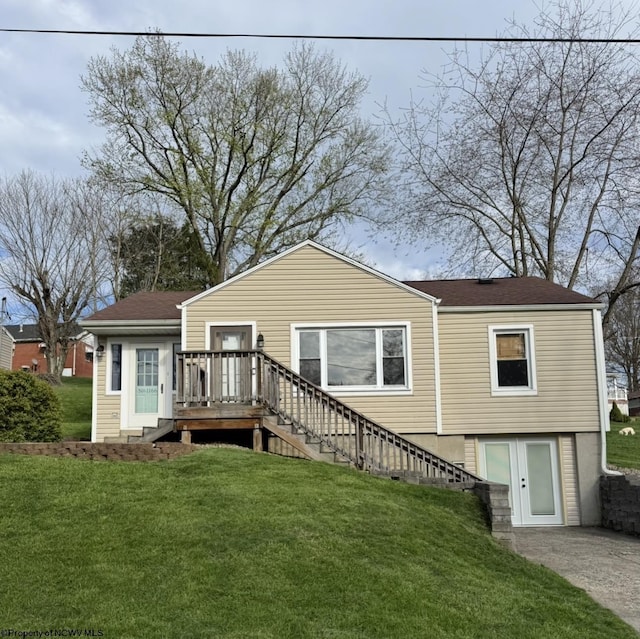 rear view of property featuring a wooden deck, stairs, and a yard