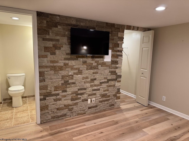 unfurnished living room featuring recessed lighting, light wood-type flooring, and baseboards