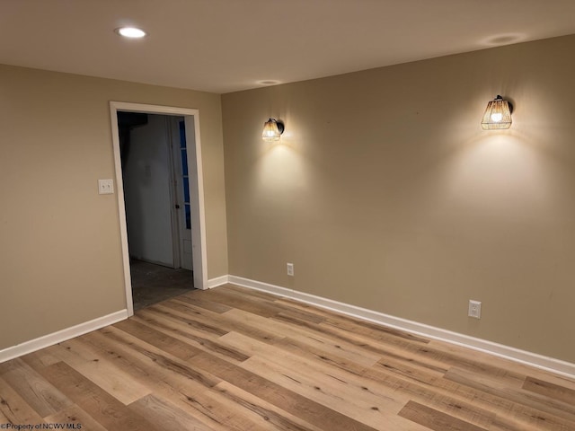 spare room featuring baseboards, light wood-style floors, and recessed lighting