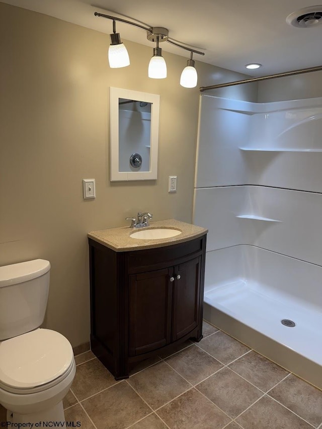 bathroom featuring toilet, vanity, tile patterned floors, and visible vents