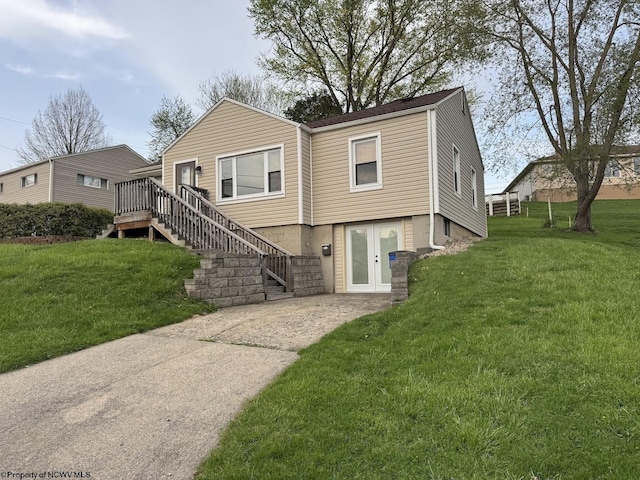 view of front of house featuring a wooden deck, a front lawn, and stairway