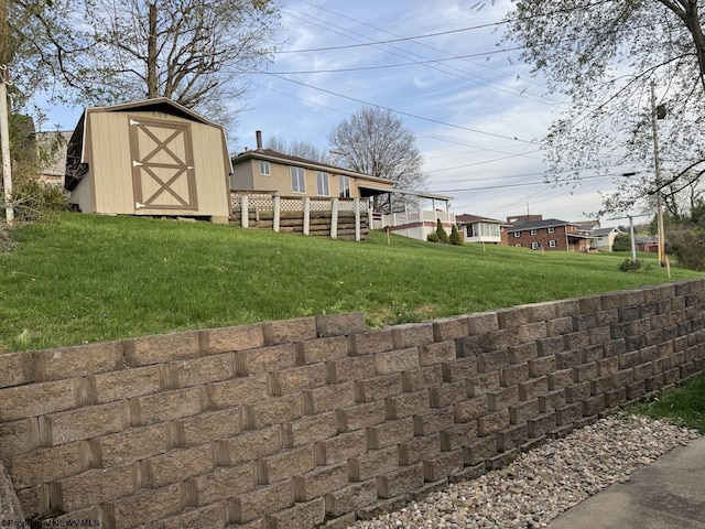 view of yard featuring an outbuilding and a storage shed
