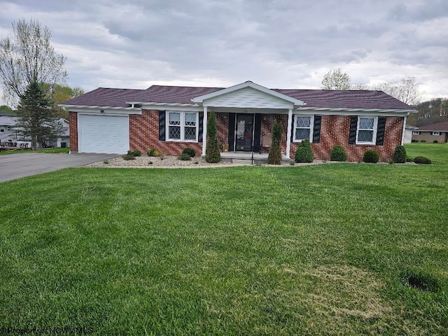 single story home featuring a front lawn, brick siding, aphalt driveway, and a garage
