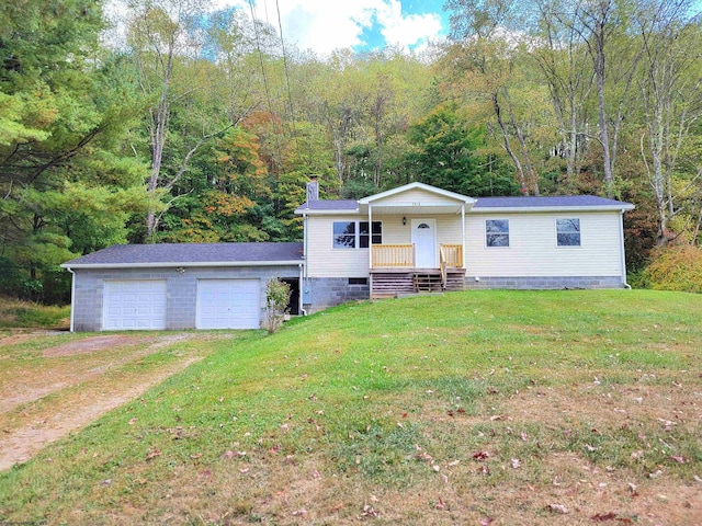 view of front of home with driveway, a chimney, a front yard, and a garage