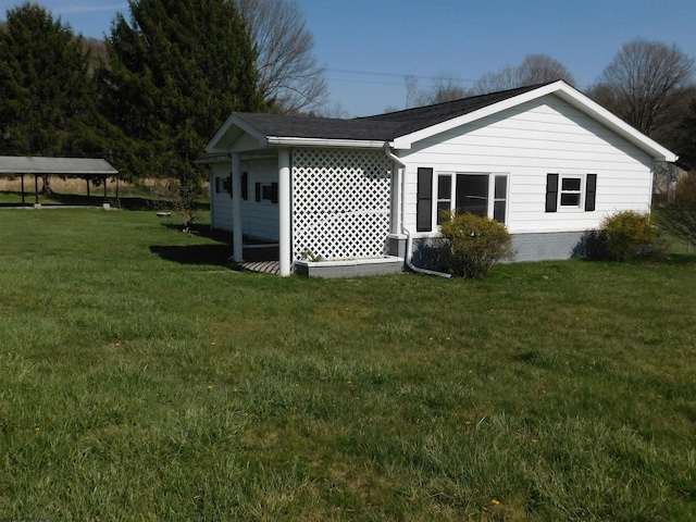 rear view of property featuring a yard