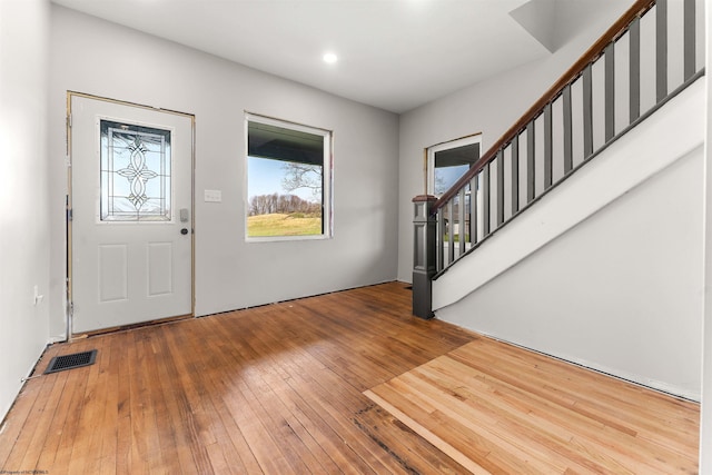 entrance foyer featuring hardwood / wood-style flooring, visible vents, recessed lighting, and stairs