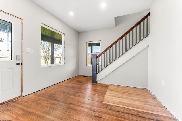 entrance foyer with recessed lighting, stairway, and hardwood / wood-style flooring