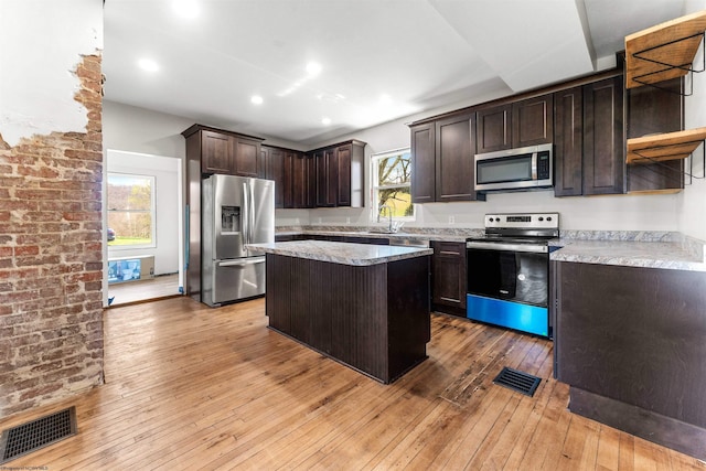 kitchen with open shelves, dark brown cabinets, visible vents, light wood-style flooring, and appliances with stainless steel finishes