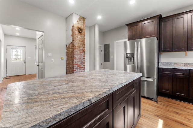 kitchen with recessed lighting, stainless steel refrigerator with ice dispenser, dark brown cabinets, and light wood-type flooring