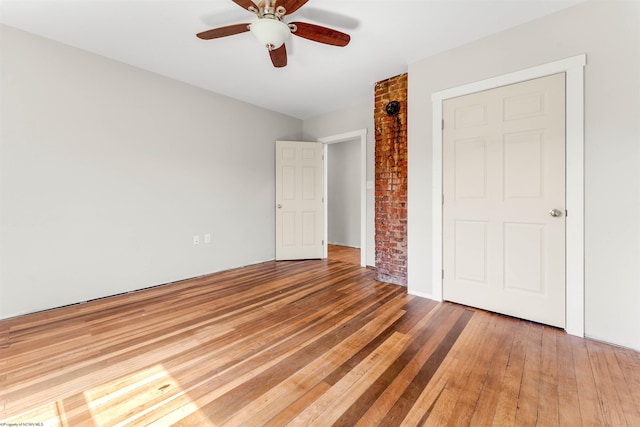 unfurnished bedroom with hardwood / wood-style floors and a ceiling fan
