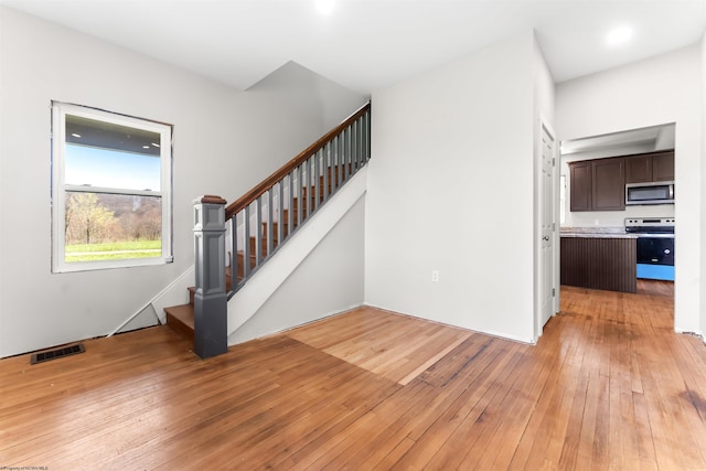stairs featuring visible vents and wood-type flooring