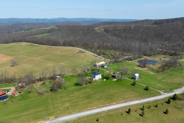 bird's eye view with a rural view, a view of trees, and a mountain view