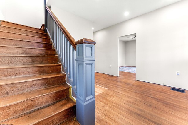 staircase featuring visible vents, wood finished floors, and recessed lighting