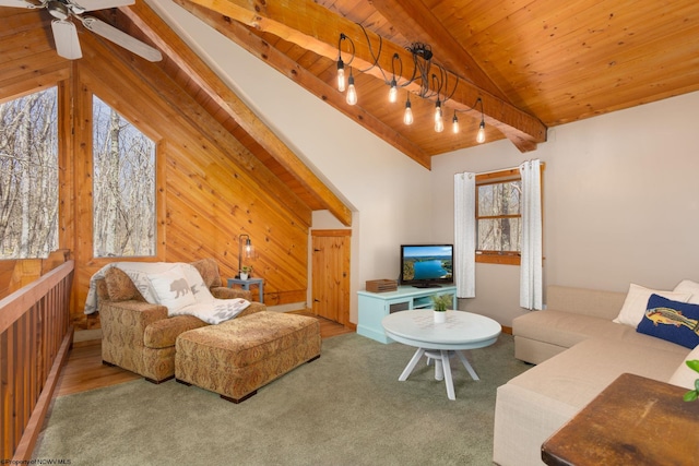 carpeted living room with a ceiling fan, wood ceiling, lofted ceiling with beams, and wood walls