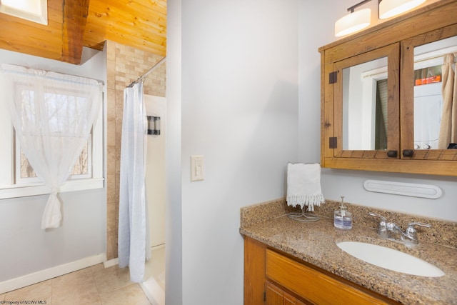 full bath with tile patterned floors, vanity, and curtained shower