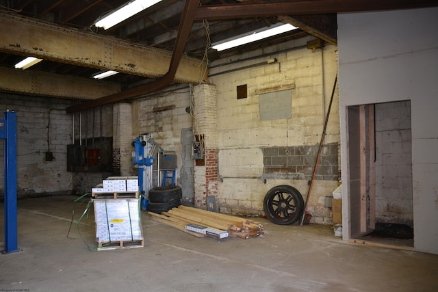 unfinished basement with concrete block wall