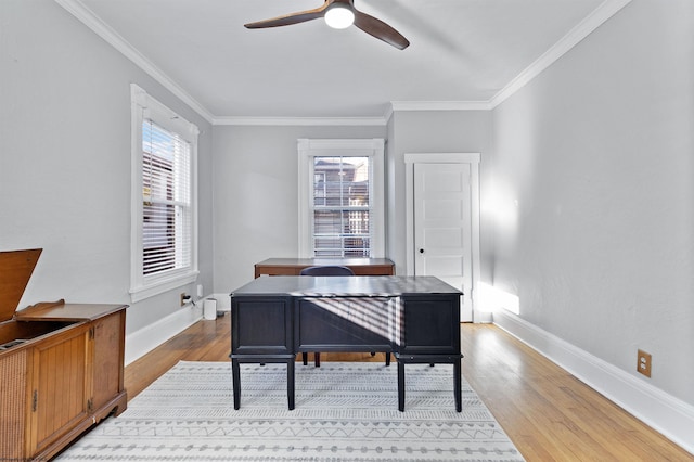 home office with wood finished floors, ornamental molding, baseboards, and ceiling fan