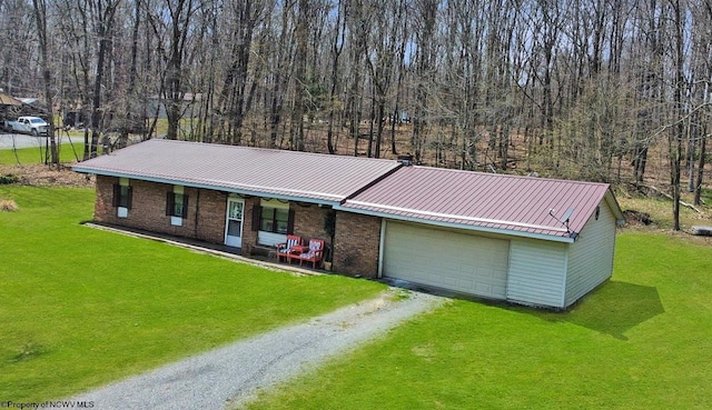 3935 Cranesville Rd, Terra Alta, WV 26764 - view of front facade with an attached garage, driveway, a porch, a front yard, and metal roof