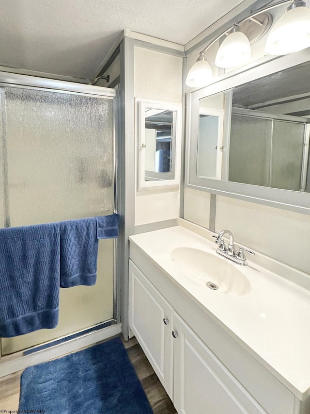 3935 Cranesville Rd, Terra Alta, WV 26764 - bathroom featuring wood finished floors, vanity, and a stall shower