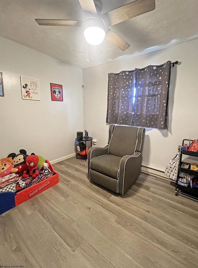 bedroom featuring baseboards, a ceiling fan, and wood finished floors