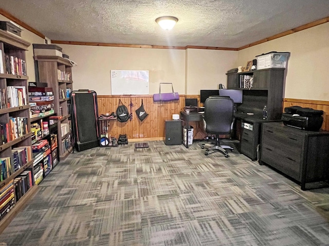 office area with wainscoting, wooden walls, a textured ceiling, and crown molding
