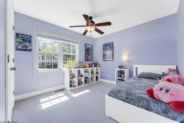 bedroom with carpet floors, visible vents, baseboards, and ceiling fan