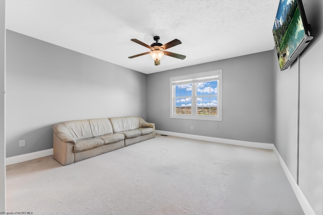 unfurnished living room with ceiling fan, baseboards, visible vents, and carpet floors