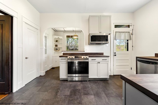 1042 Fort Martin Rd, Maidsville, WV 26541 - kitchen featuring wood counters, stainless steel appliances, stone finish floor, and arched walkways