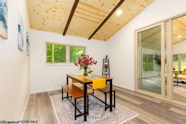 dining space with wooden ceiling, lofted ceiling with beams, and a healthy amount of sunlight