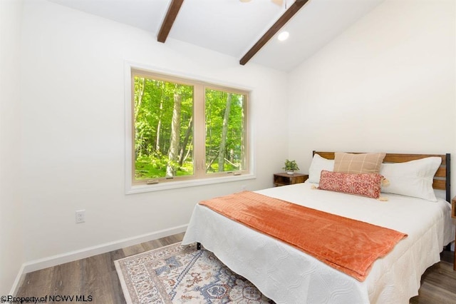 bedroom featuring baseboards, wood finished floors, and lofted ceiling with beams