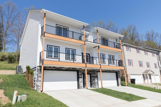 69 Hall Valley Ct, Bridgeport, WV 26330 - view of front of home with concrete driveway, central AC unit, a balcony, and an attached garage
