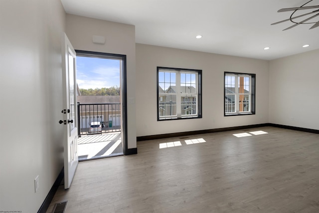 empty room with recessed lighting, ceiling fan, wood finished floors, and baseboards