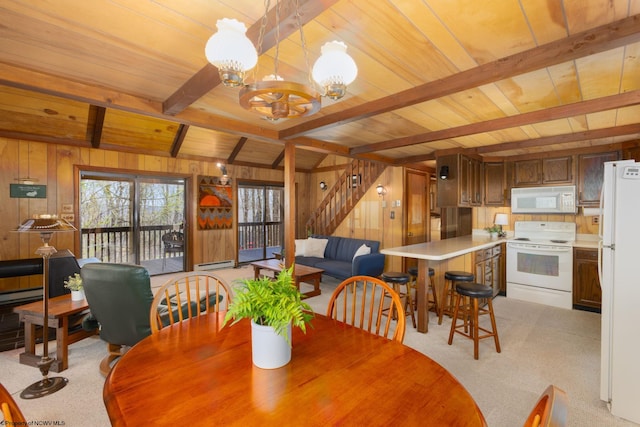 dining area with wood ceiling, beam ceiling, stairway, a notable chandelier, and wooden walls