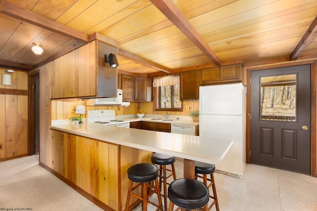 kitchen with white appliances, wood ceiling, light countertops, beam ceiling, and a peninsula
