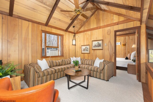 living area with wood walls, vaulted ceiling with beams, cooling unit, and plenty of natural light