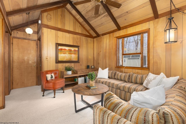 living area with ceiling fan, vaulted ceiling with beams, wooden walls, wood ceiling, and carpet floors