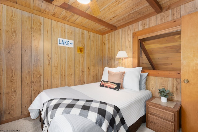 bedroom featuring wooden walls, carpet flooring, beamed ceiling, and wooden ceiling