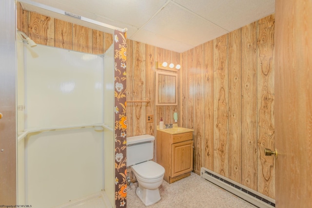 full bath featuring a baseboard heating unit, vanity, toilet, wooden walls, and walk in shower