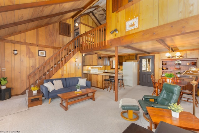 living room with wood walls, stairs, carpet floors, and wood ceiling